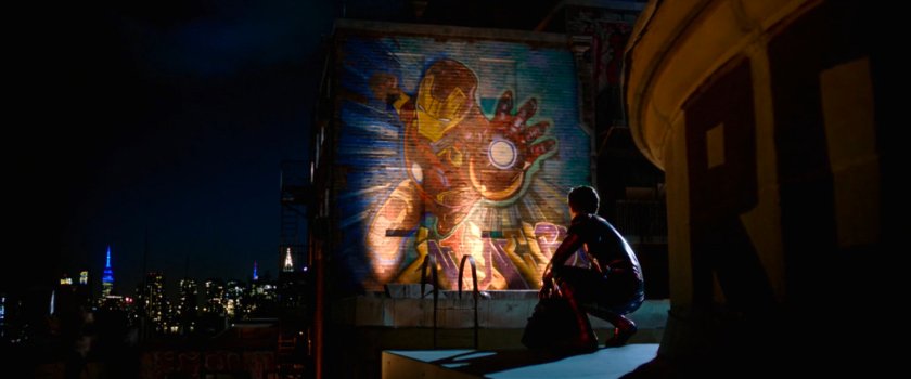 Spider-Man looking at Iron Man mural on the roof of the queens Cultural Center.