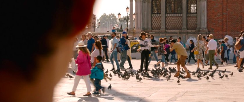 Michelle having photos taken with pigeons in St Marks Square Venice.