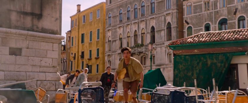 Students run past overturned chairs in Santa Maria Formosa Square.