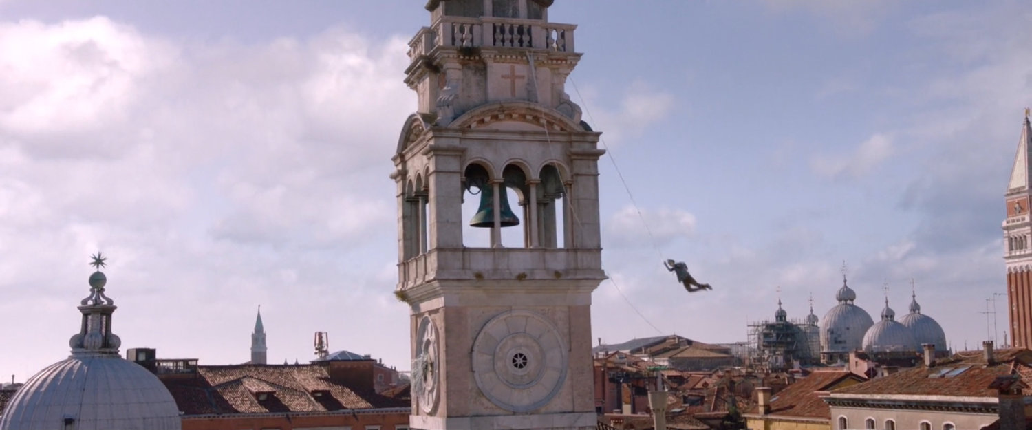 Spider-Man swinging around tower in Santa Maria Formosa Square.
