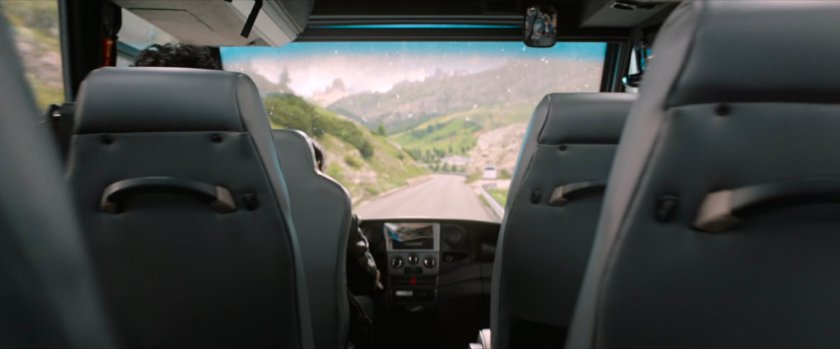 POV from inside tour bus on mountain road.