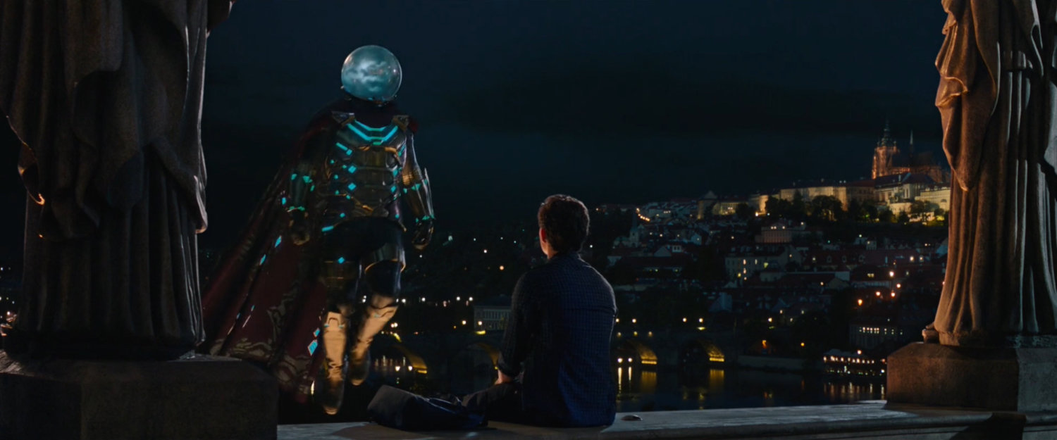 Mysterio hovers as Peter sits on the railing of a concrete balcony in Prague.