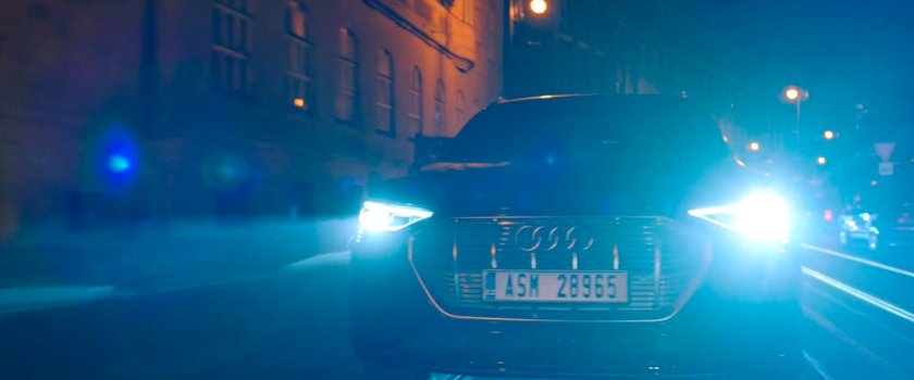 A car on a nighttime Prague street. License plate: ASM 28965.