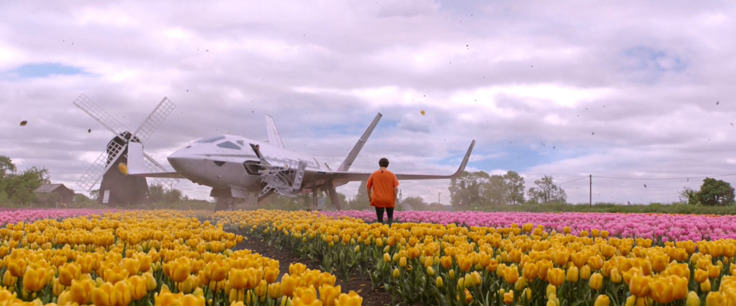 Peter Parker walks towards a small jet in a tulip field in the Netherlands.