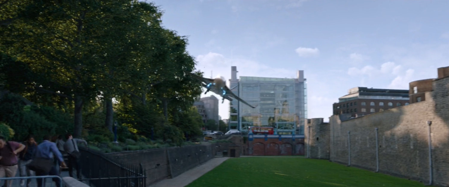 A small private jet flies past the walls of the Tower of London.