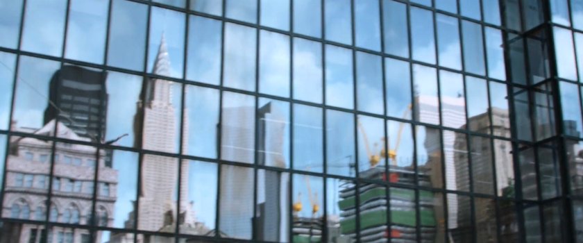 Reflection of New York and Empire State Building in another skyscraper window.