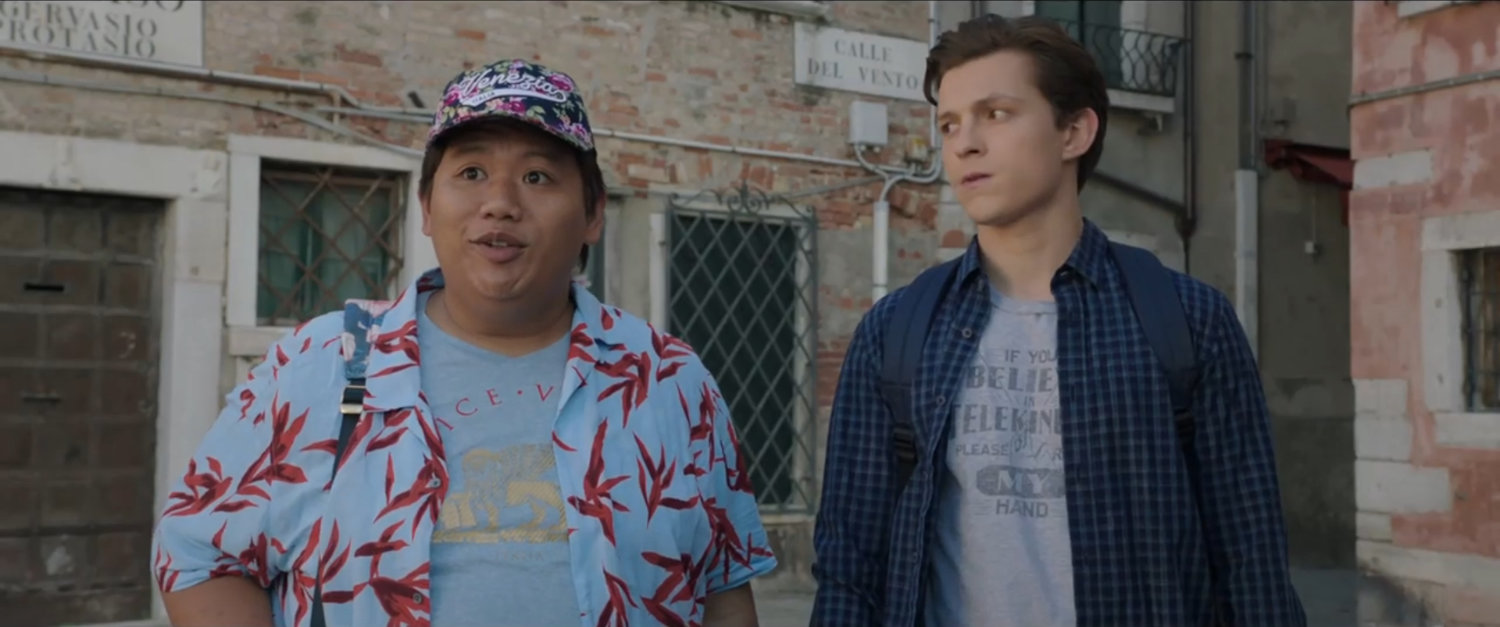 Ned and Peter stand in front of Venetian building with street sign.