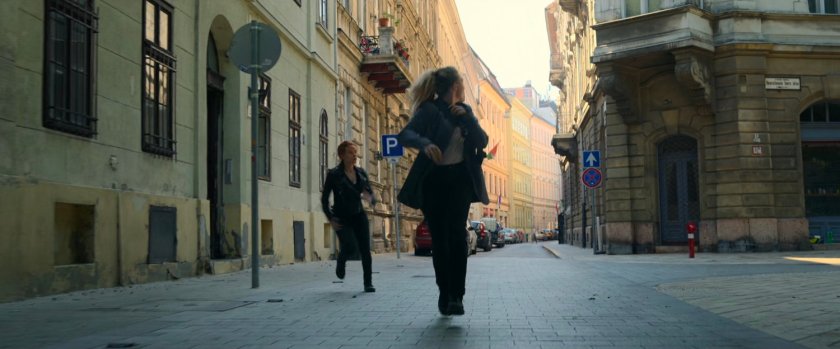 Yelena and Natasha run into an alley in Budapest.