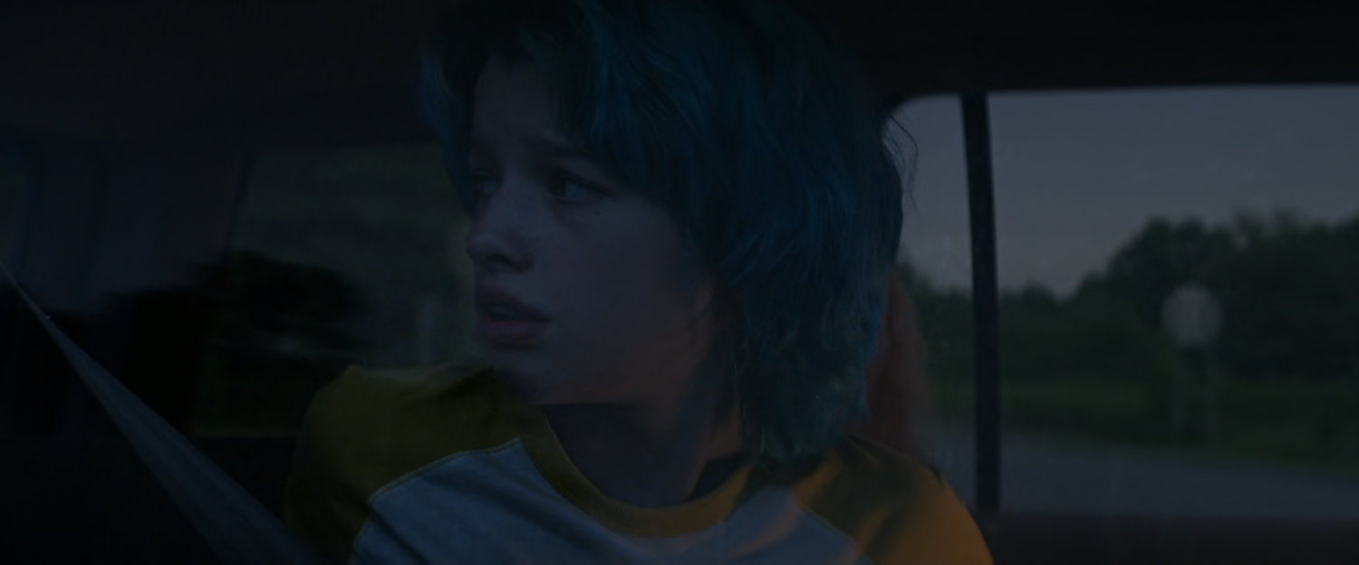 Young Natasha in back of car.