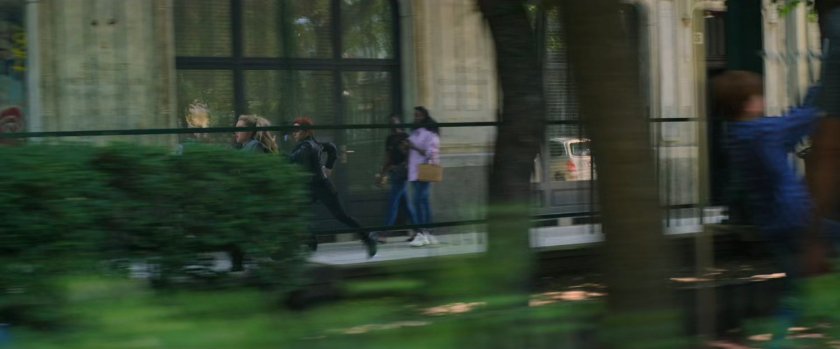 Out of focus playground with Yelena and Natasha running  in background.