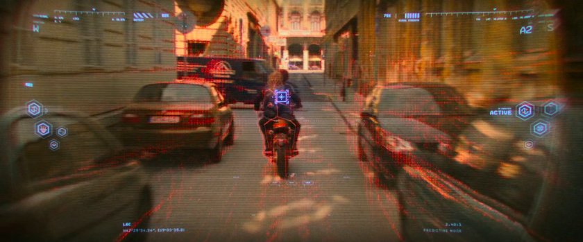 Digitally enhanced POV of motorcycle speeding down alley.