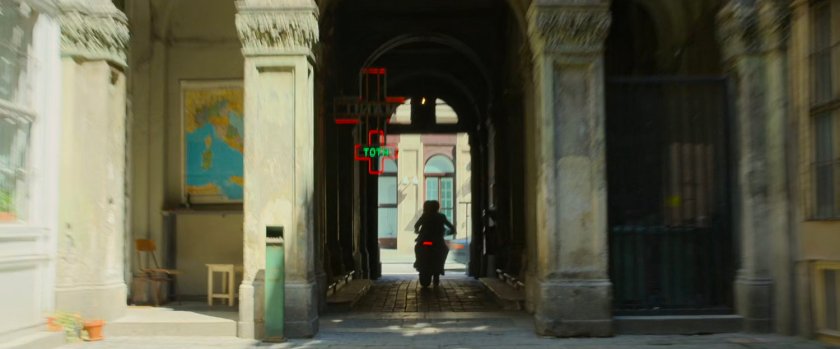 Motorcycle drives through Budapest archway.