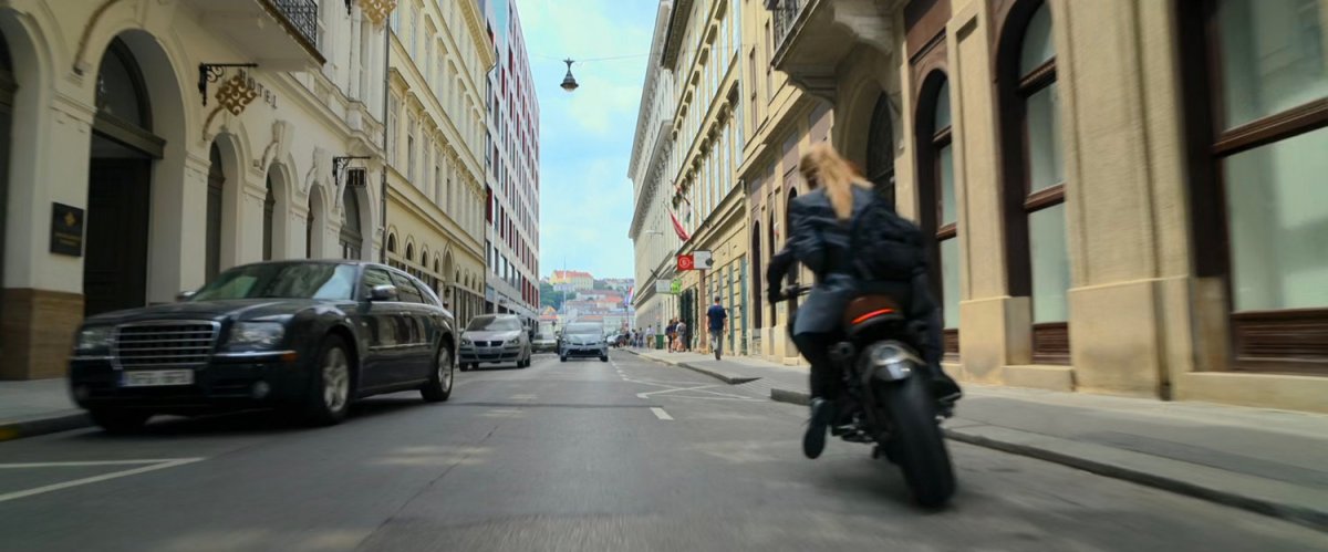 Motorcycle racing the wrong way down a street in Budapest.