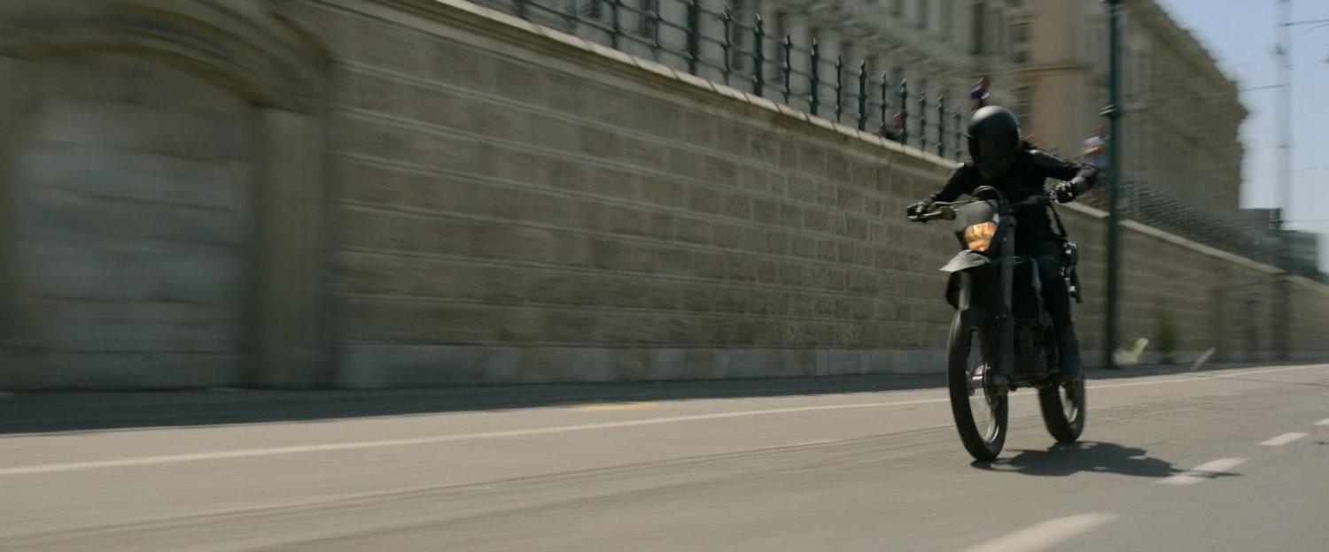 A motorcycle races along a Budapest street.