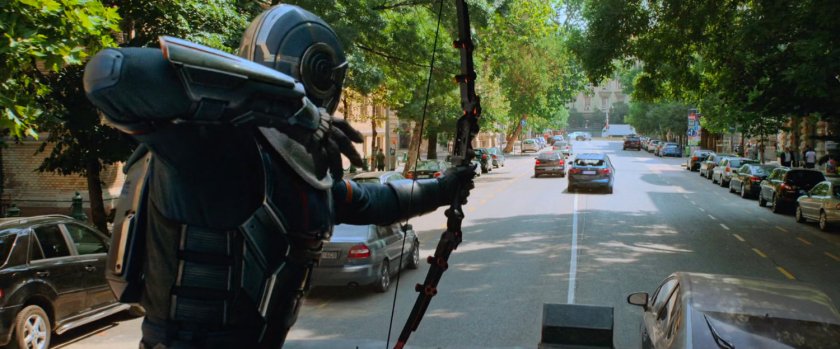 Taskmaster fires an arrow at a small car on a Budapest street.