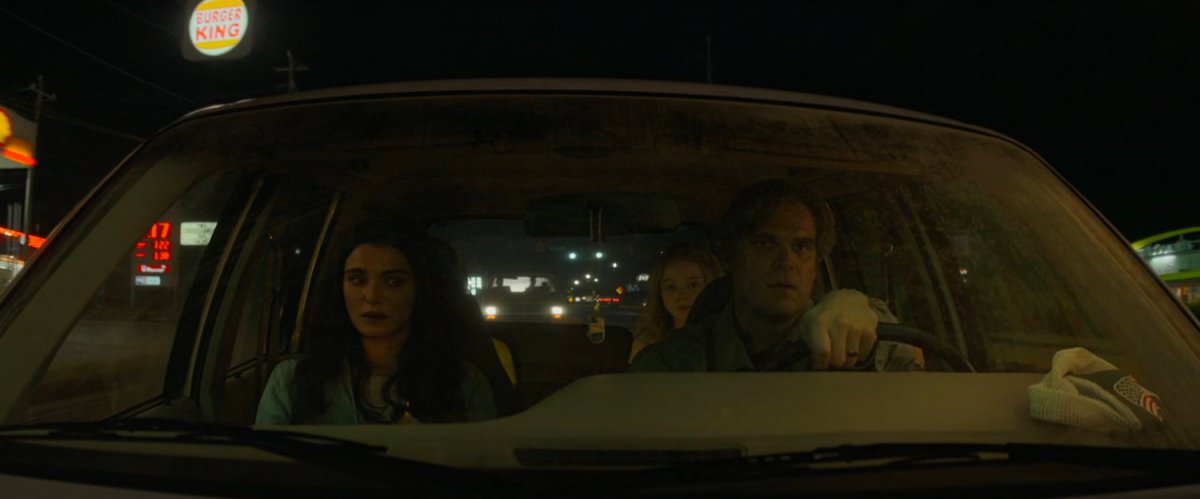 Alexei and Melina in family car with Burger King sign outside.