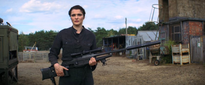 Melina with a rifle outside her homestead.