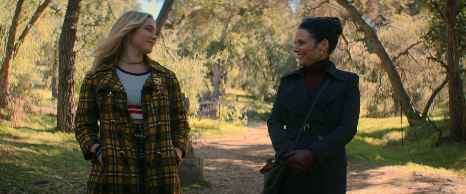 Yelena and Valentina in a wooded cemetery.