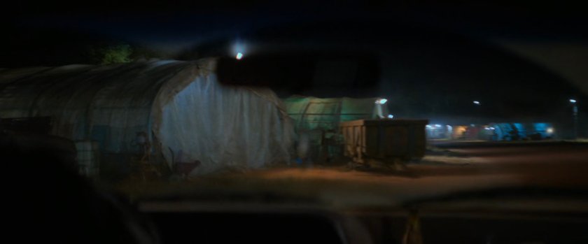 Tarp covered sheds at a small airfield.