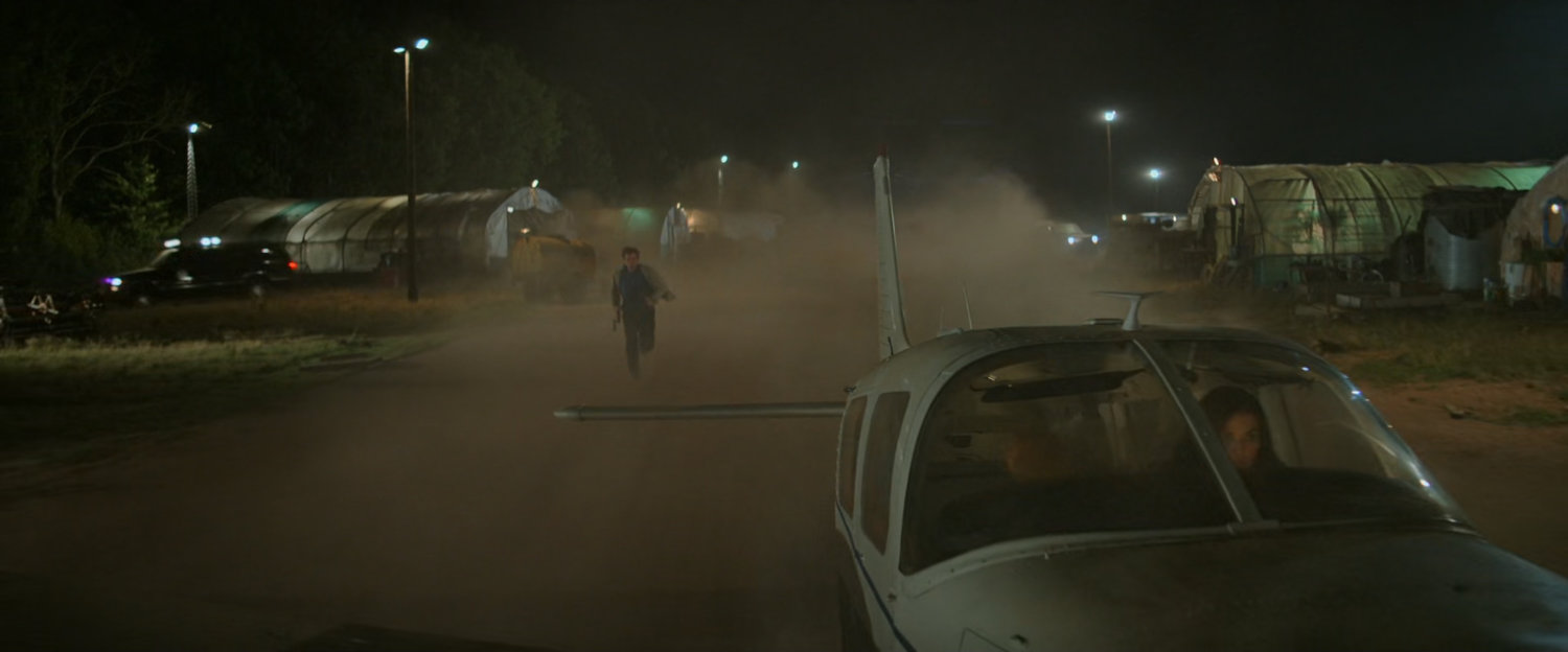 Alexei running after Cessna on a dirt runway.