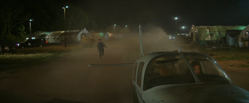 Alexei running after Cessna on a dirt runway.