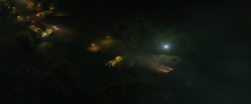 Aerial view of Cessna taking off from small airfield.