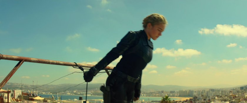 Yelena begins to rappel from a roof in Morrocco.