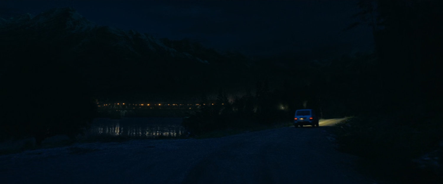 Car on Norwegian road at nighttime.