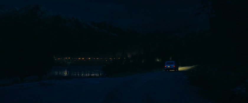 Car on Norwegian road at nighttime.