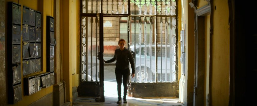 Natasha entering an apartment complex.