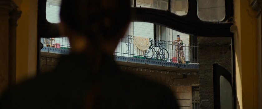 View of apartment balcony over Natasha's shoulder.