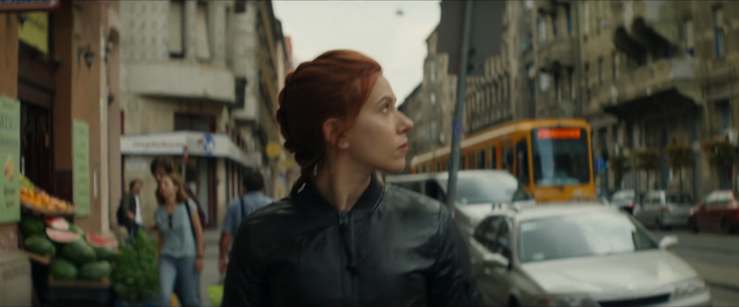 Natasha looking over her shoulder at something on a Budapest sidewalk.