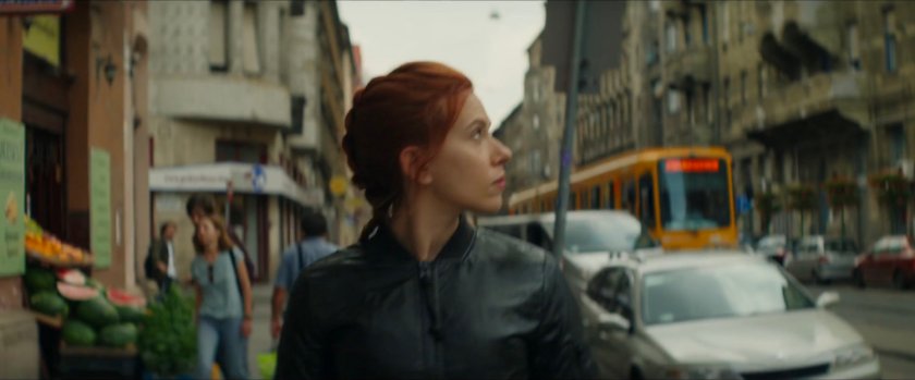 Natasha looking over her shoulder at something on a Budapest sidewalk.