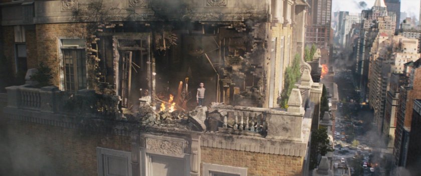 Young Kate Bishop looks out of damaged penthouse wall.