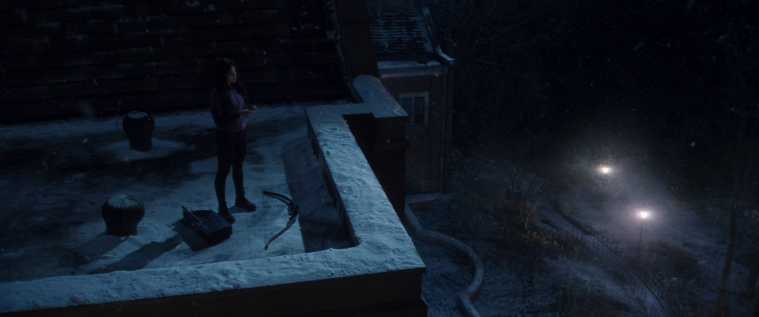 Kate on rooftop of college campus building.