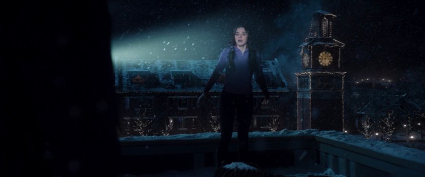 Kate on rooftop of college campus building.