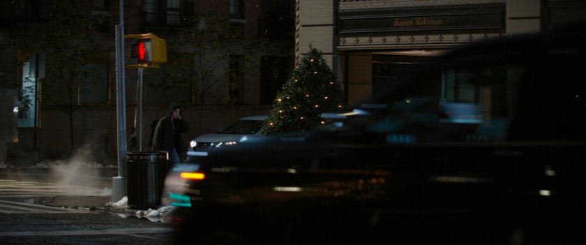Kate walks along sidewalk outside Bishop Penthouse building.