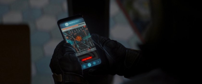 Close-up of hands holding a phone with a map app open.