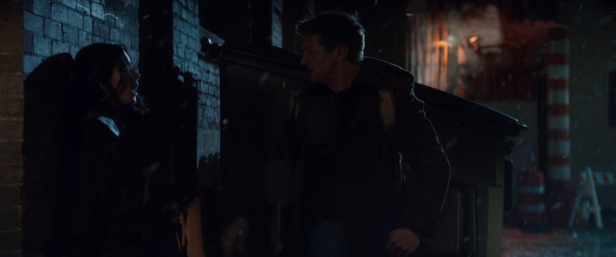 Clint unmasks Kate in a dark alley.