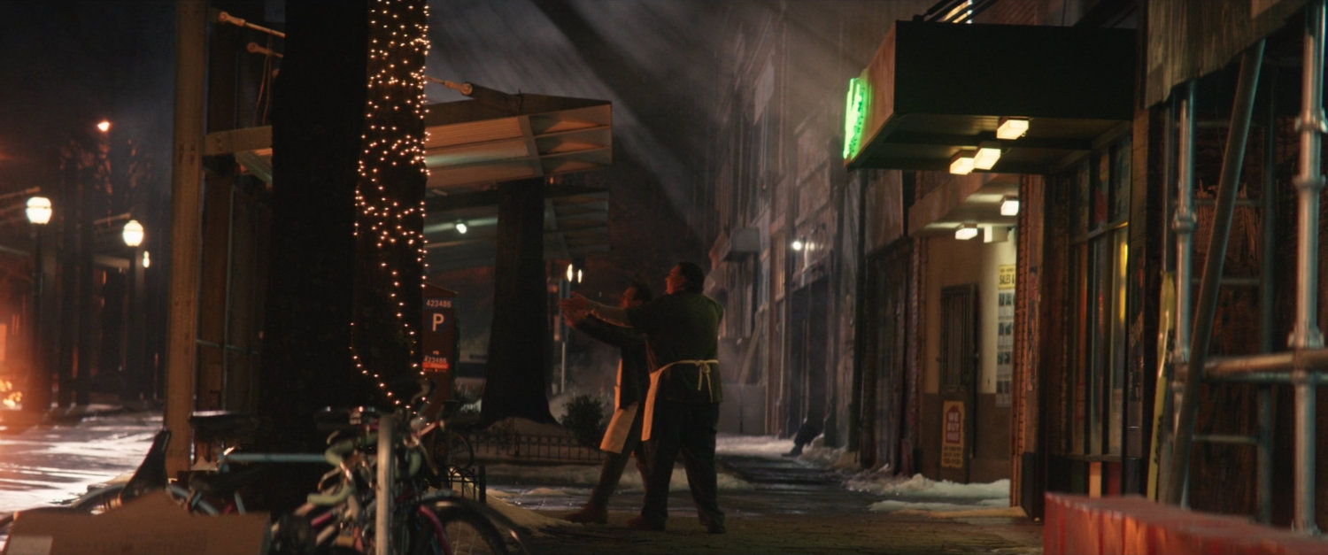 Two men outside Herman's Hearty Slice.
