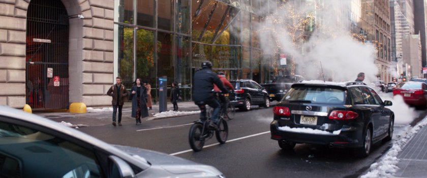 Clint and Kate crossing the street outside Bishop Security.