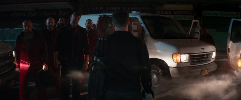 Clint confronted by the tracksuit mafia in front of a New York shipping store.