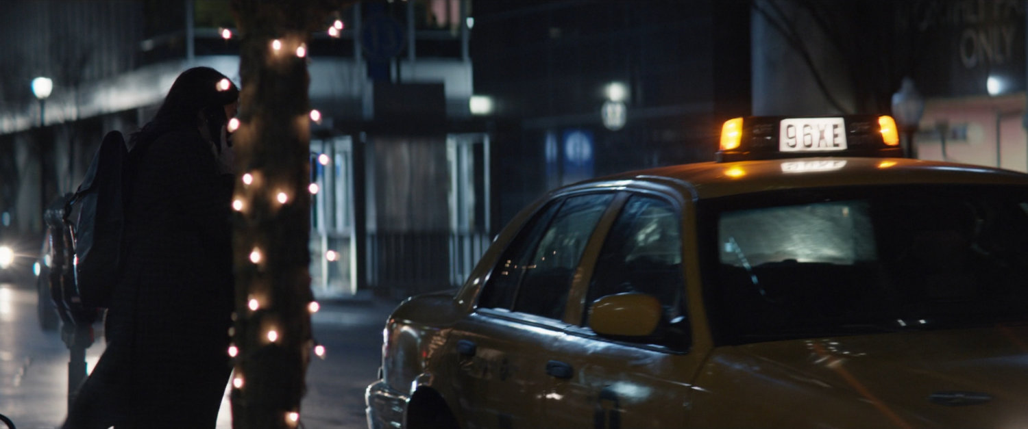 Kate approaching a taxi cab.