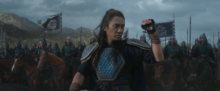 Wenwu on horseback signals his troops to stop.