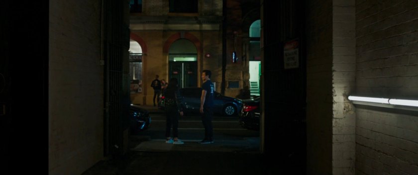 Shaun and Katy walk through an alley.