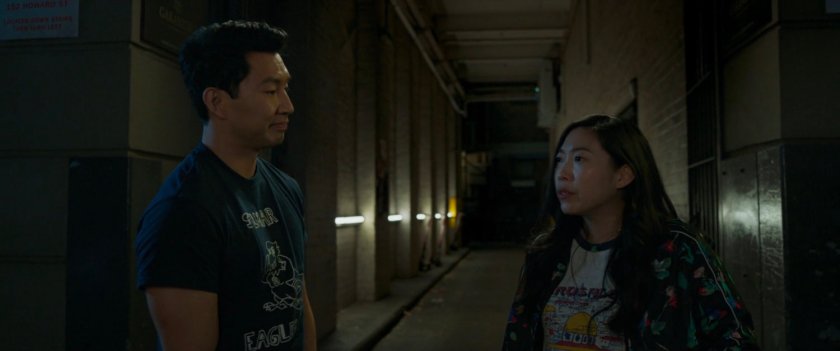 Shaun and Katy walk through an alley.