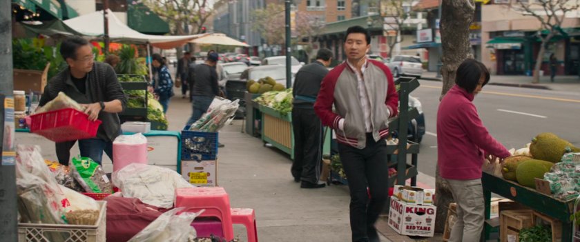 Shaun walking by grocers on a San Francisco sidewalk.