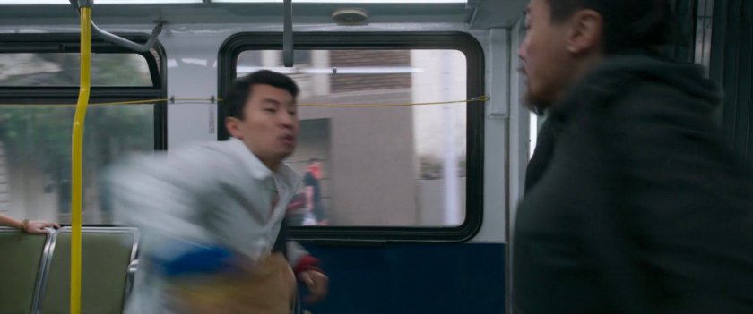 Shaun whips his jacket around on a San Francisco metro bus.