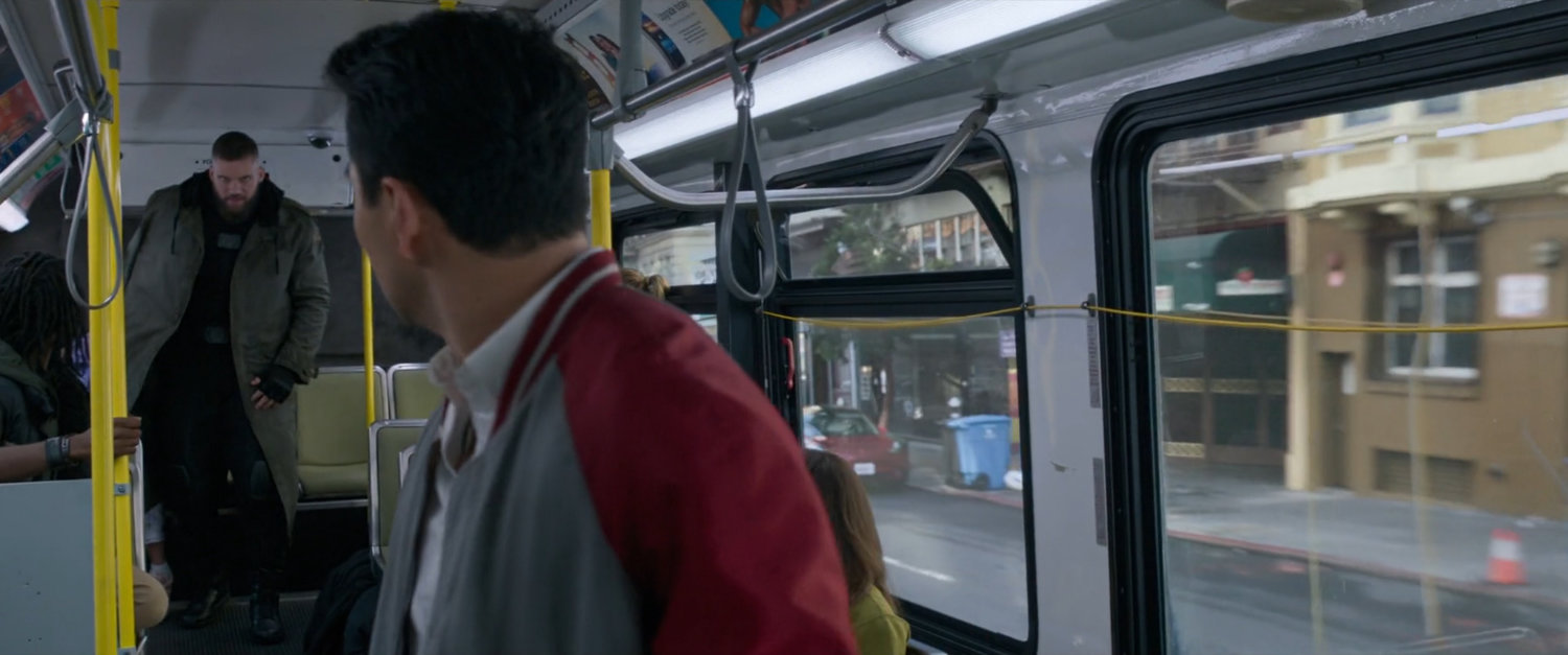Shaun looking over his shoulder at Razorfist on a San Francisco metro bus.