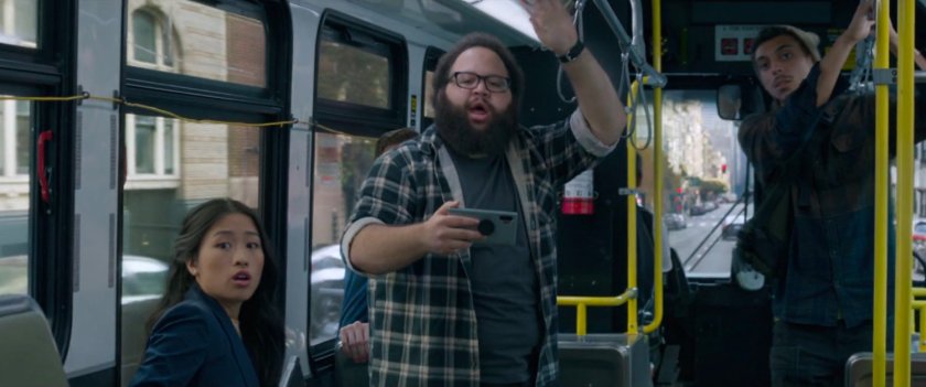 Onlookers watch a fight on a San Francisco metro bus.